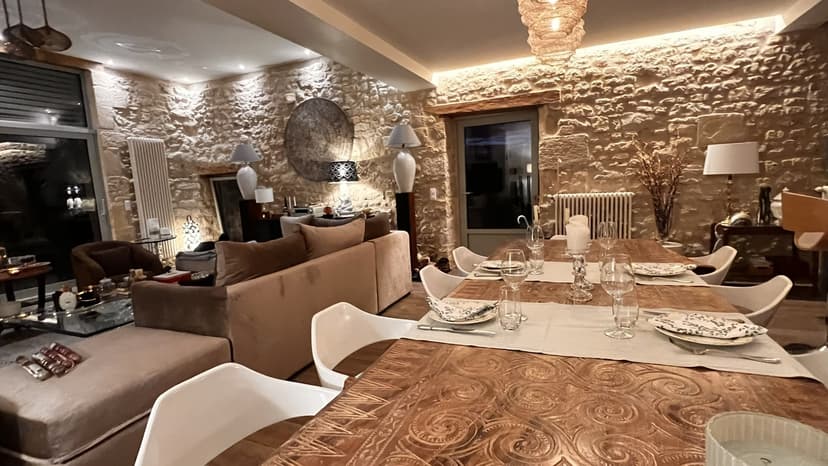 Elegant interieur van een luxe villa in de Dordogne met stenen muren, gedekte tafel en gezellige salon